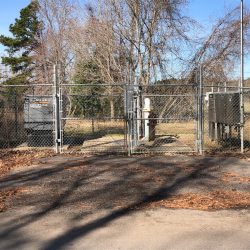 Industrial power system behind chain link fence